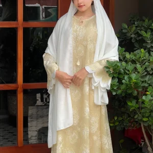 Woman wearing an elegant off-white embroidered salwar suit with a matching dupatta and traditional ethnic design.